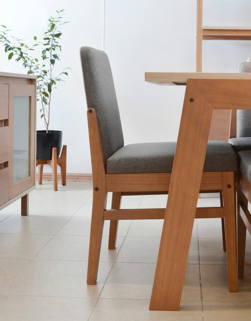 Modern dining chairs and table in a well-lit room.